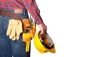 Construction worker with toolbelt on white